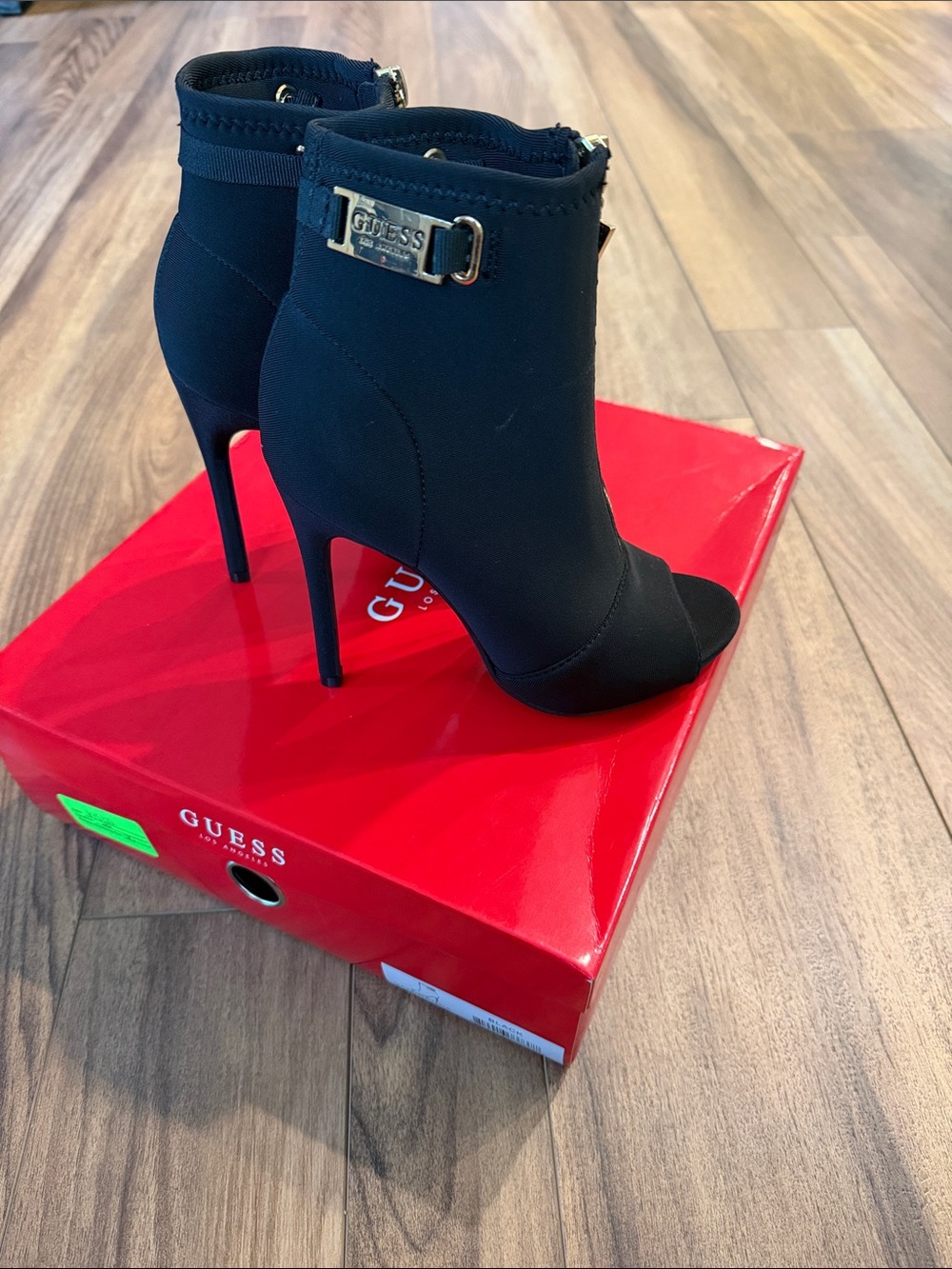 GUESS Black Peep-Toe Stiletto Ankle Booties with Gold Logo Plate